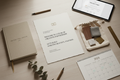 A flat lay of the annual access welcome package — letterhead, linen notebook, material samples, calendar, and client portal tablet